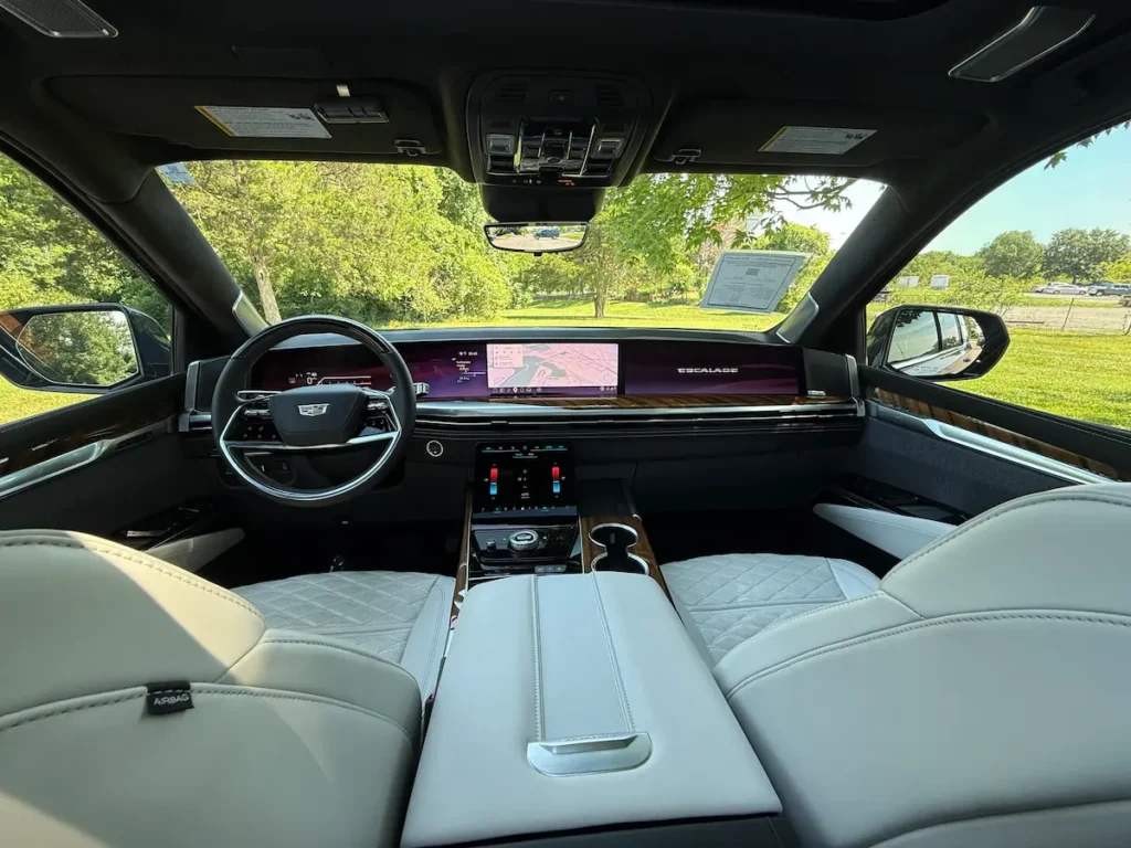Dashboard and front interior of a 2026 Cadillac Escalade with curved digital display