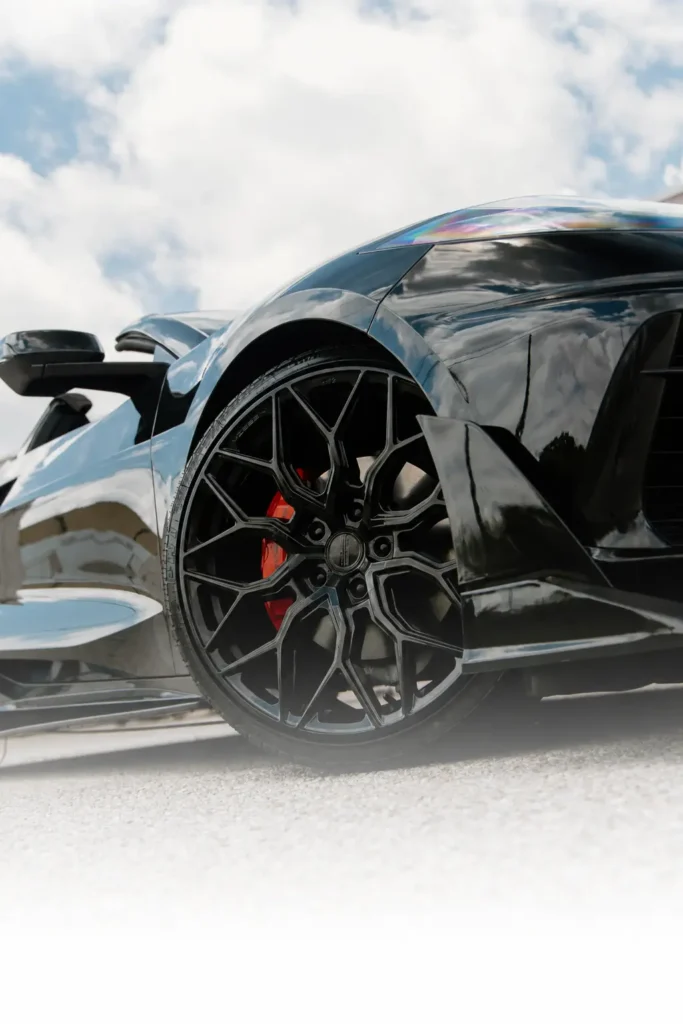 Black Chevrolet Corvette Stingray 2LT wheel with a red brake caliper