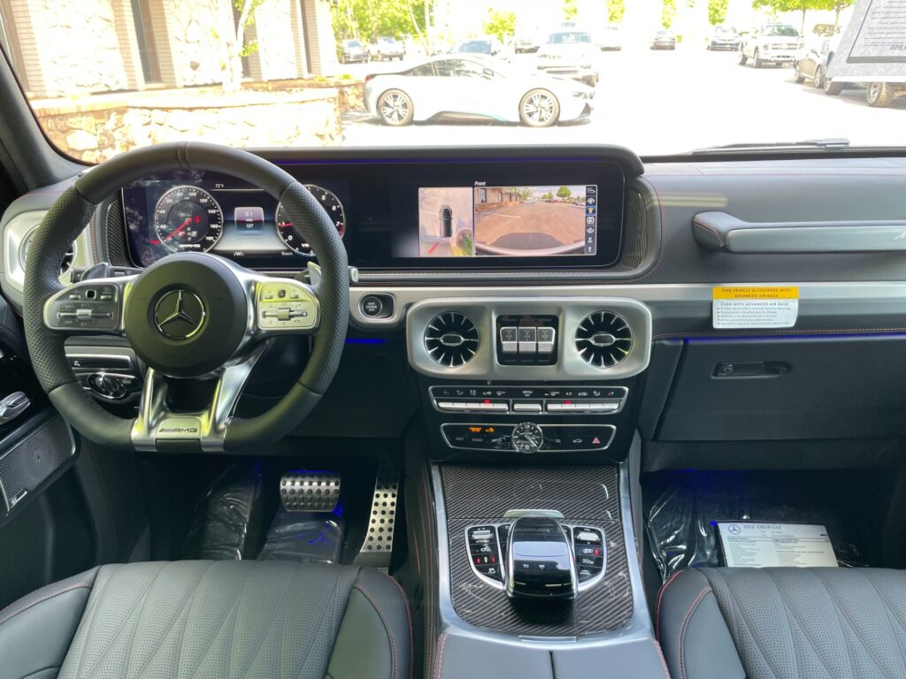 Mercedes-Benz G63 AMG SUV interior with leather steering wheel and digital dashboard