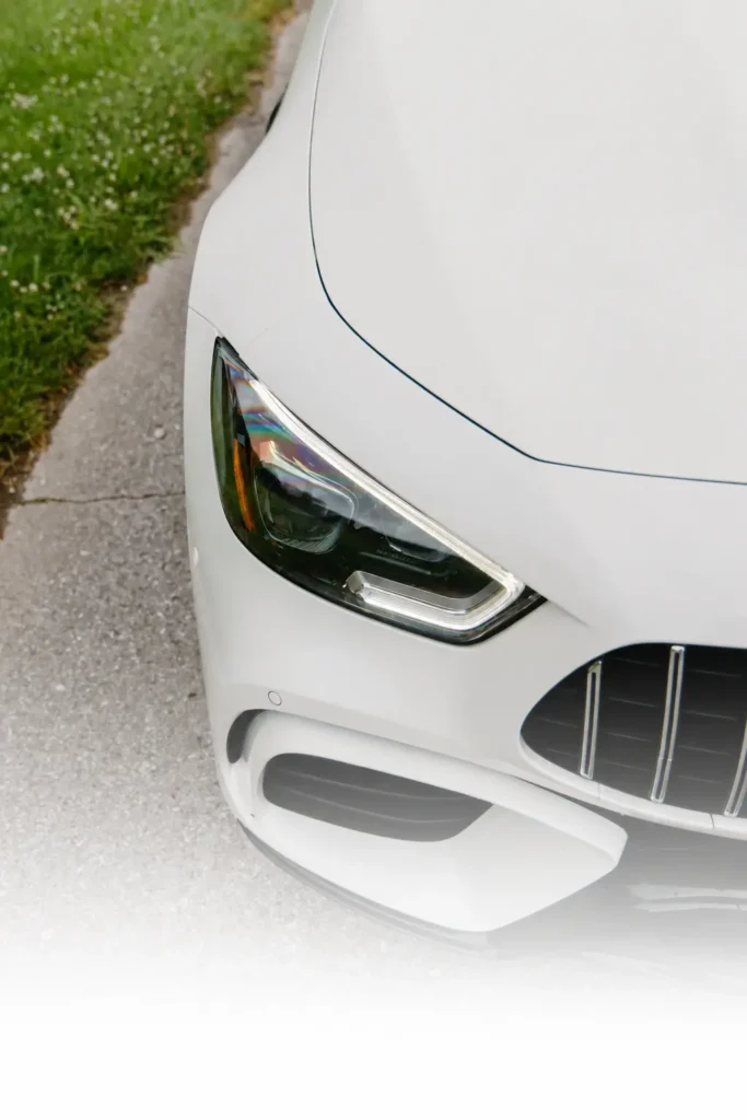 Close-up of a white Mercedes-Benz G 63 AMG headlight and front grille