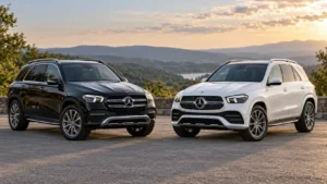 Black and white Mercedes-Benz GLE SUVs parked side by side at a scenic overlook, viewed from the front.