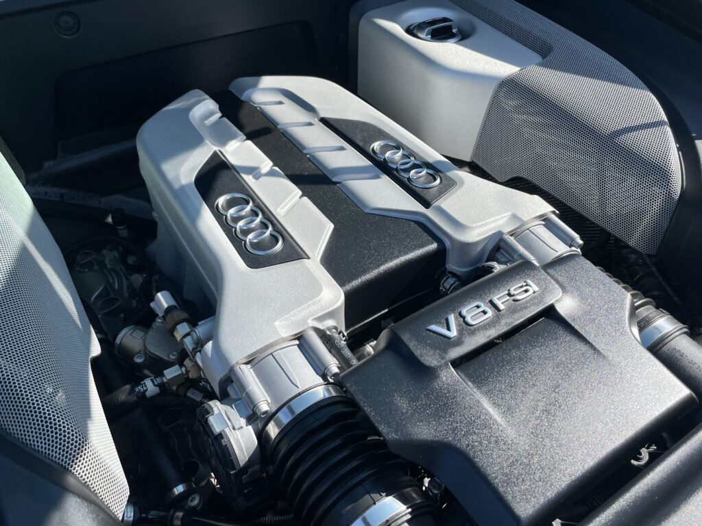 Close-up of a powerful V8 FSI engine in a sleek black engine bay.