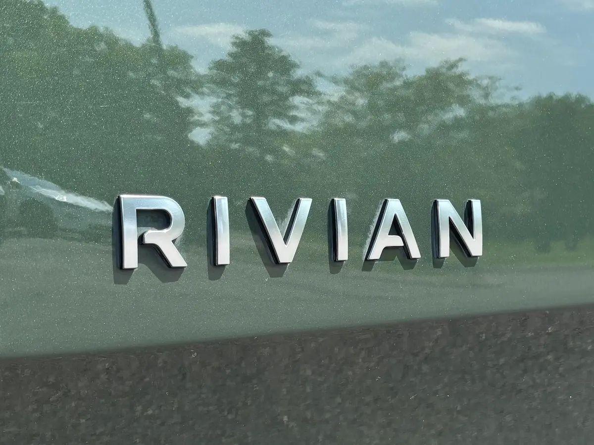 Rivian lettering on the rear of a green Rivian electric vehicle