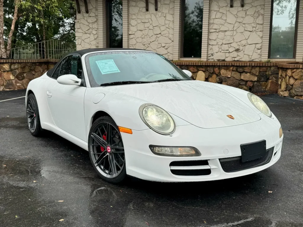 Used 2005 Porsche 911 Carrera S Cabriolet Sport in white, parked in front of a building.