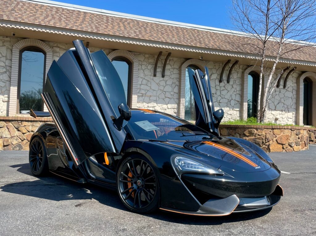 Used 2016 McLaren 570S with doors open, showcasing luxury and carbon fiber packages.
