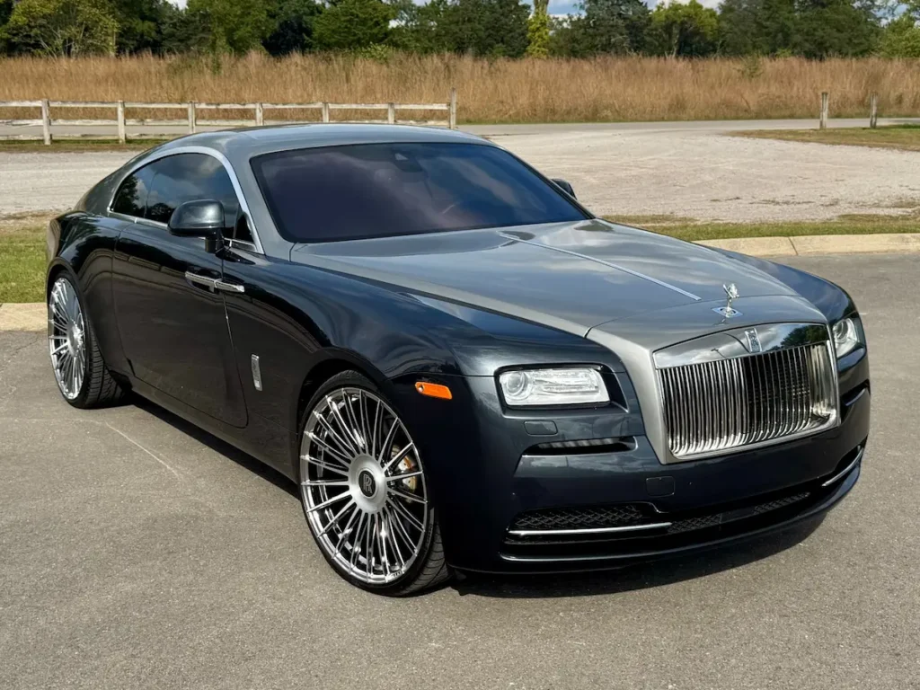 2016 Rolls-Royce Wraith luxury coupe in black and silver finish with signature grille and chrome accents.