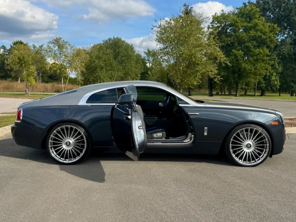 2016 Rolls-Royce Wraith side profile with open coach door revealing blue-accented interior.