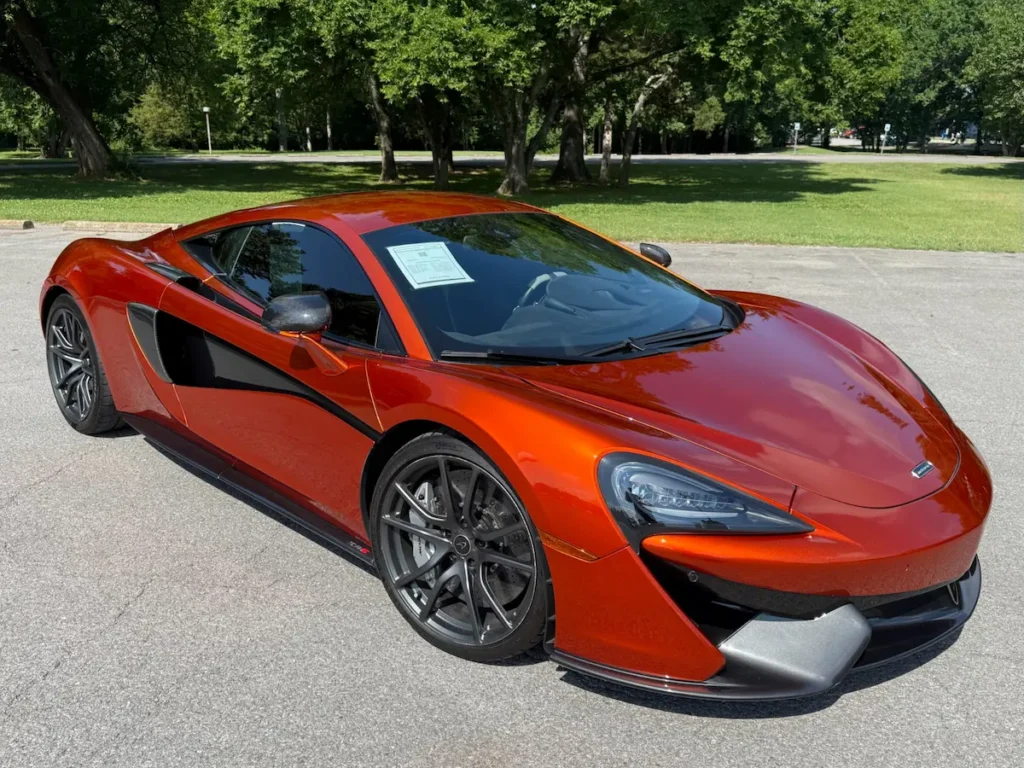 Front three-quarter view of a 2017 McLaren 570S in vibrant orange with black aero panels.