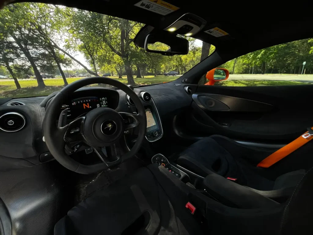 Interior of McLaren 600LT showing Alcantara dashboard and carbon trim.