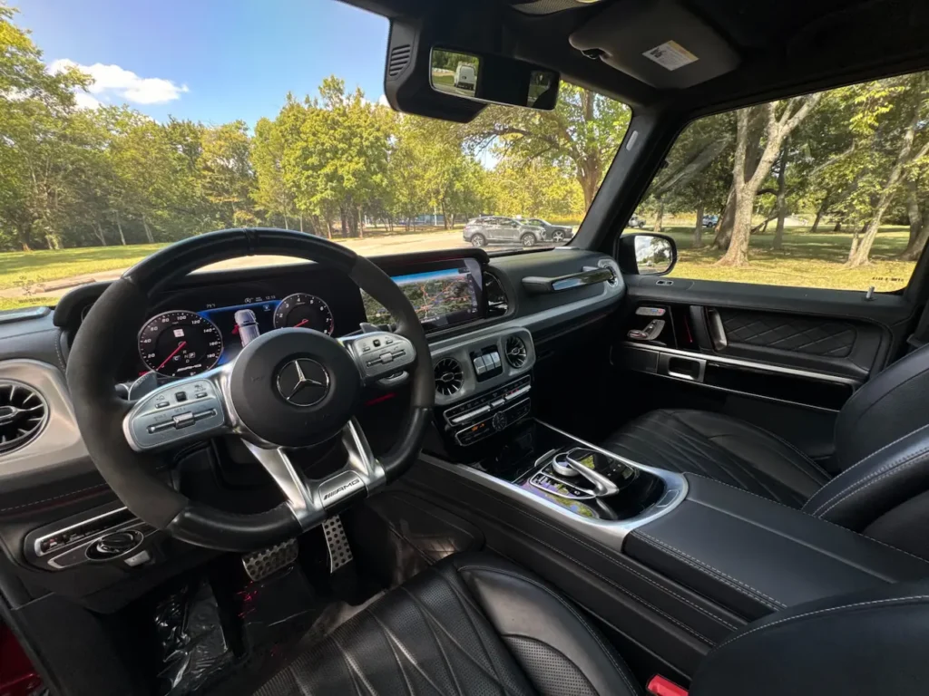 Mercedes-Benz G63 AMG interior showing AMG steering wheel and digital display