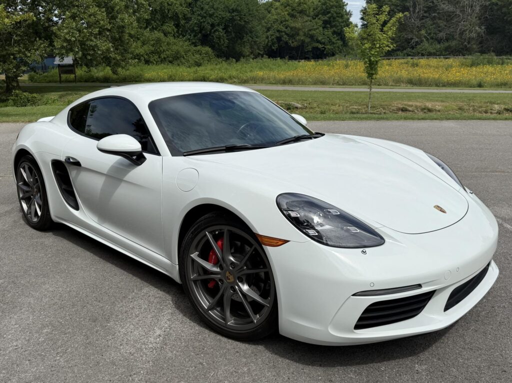 Front view of white 2019 Porsche 718 Cayman S with LED headlights and Sport Chrono Package.