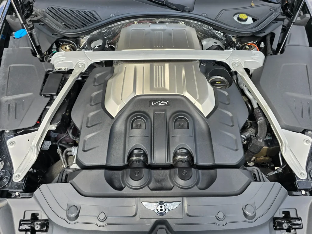 Close-up of the engine of a 2020 Bentley Continental GT V8 Coupe, showcasing its powerful V8 engine, captured at AutoPro Nashville.