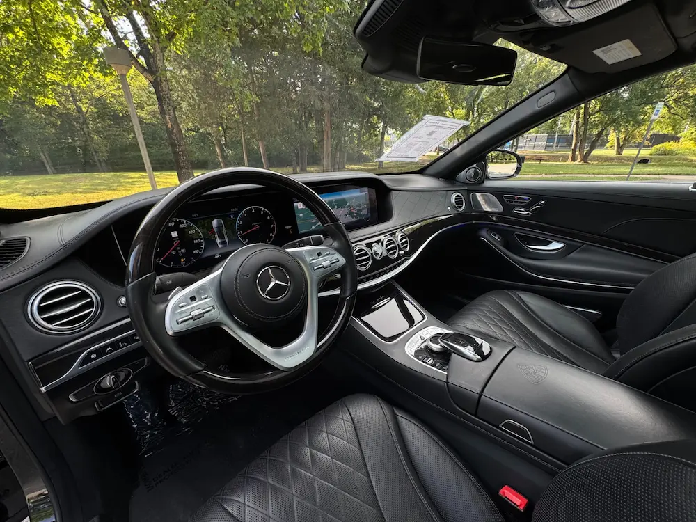 Interior of Mercedes-Maybach S 650 featuring diamond-stitched leather seats and digital display.