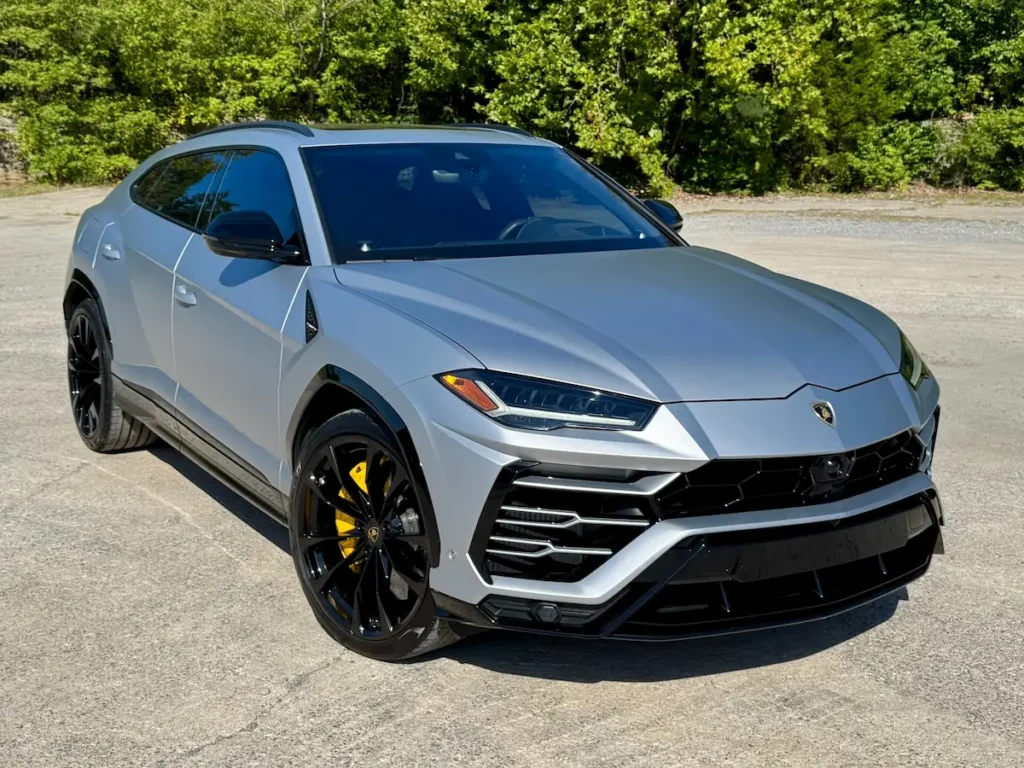 2021 Lamborghini Urus front view showing Y-shaped LED headlights and sporty grille.