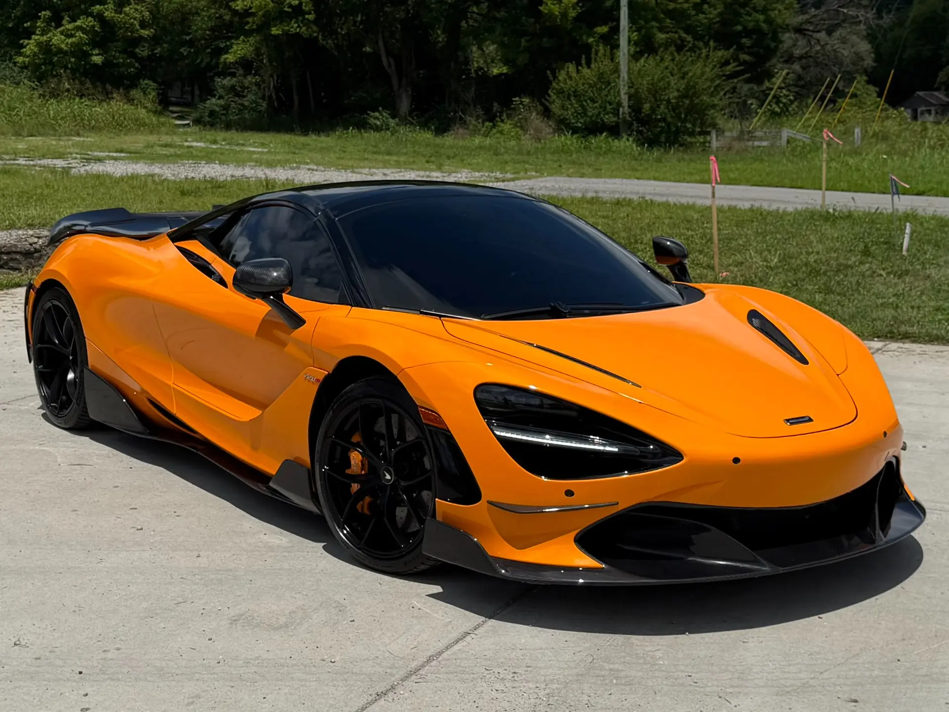Orange 2021 McLaren 720S Spider Performance with black carbon-fiber details.