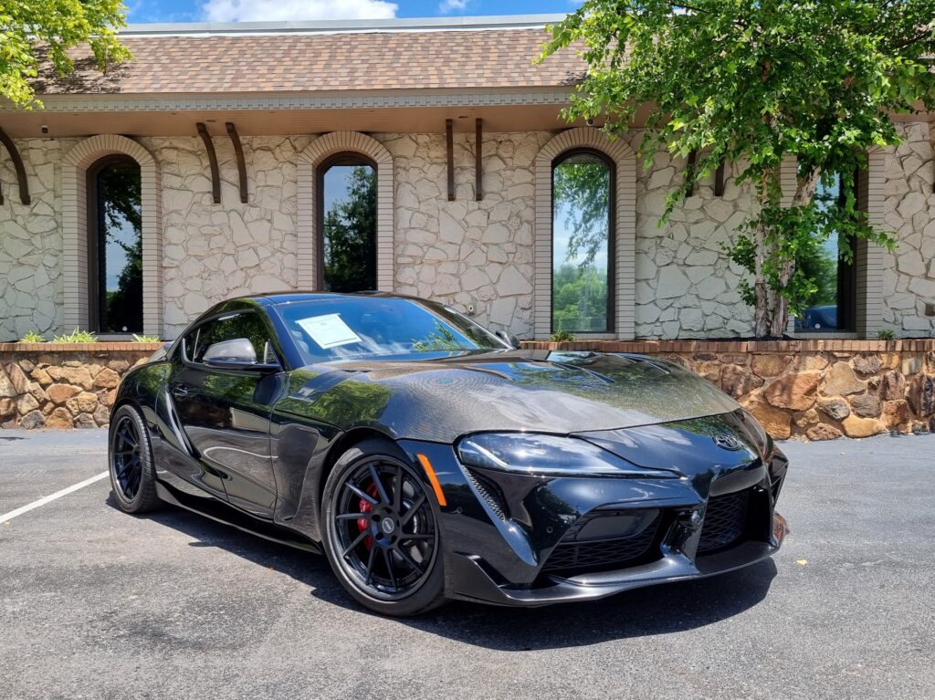 Used 2021 Toyota GR Supra 3.0 Premium with Driver Assist Package parked outside AutoPro Nashville, a used car dealership.