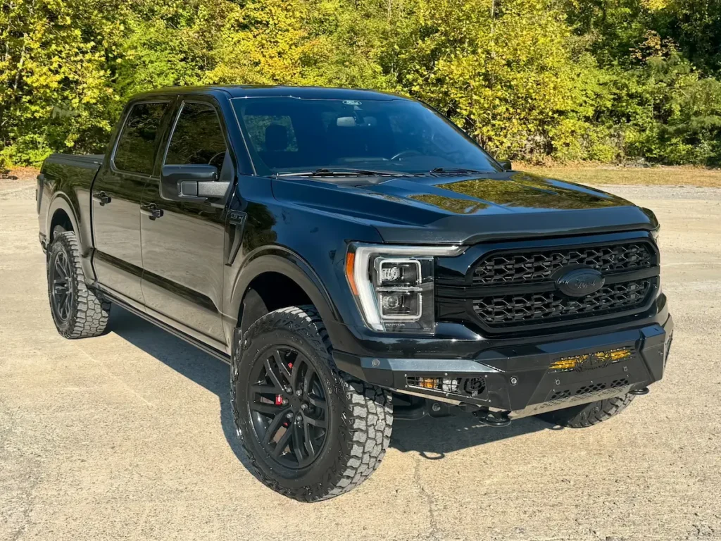 Front view of a black 2022 Ford F-150 King Ranch showing bold grille, LED headlights, and off-road tires.