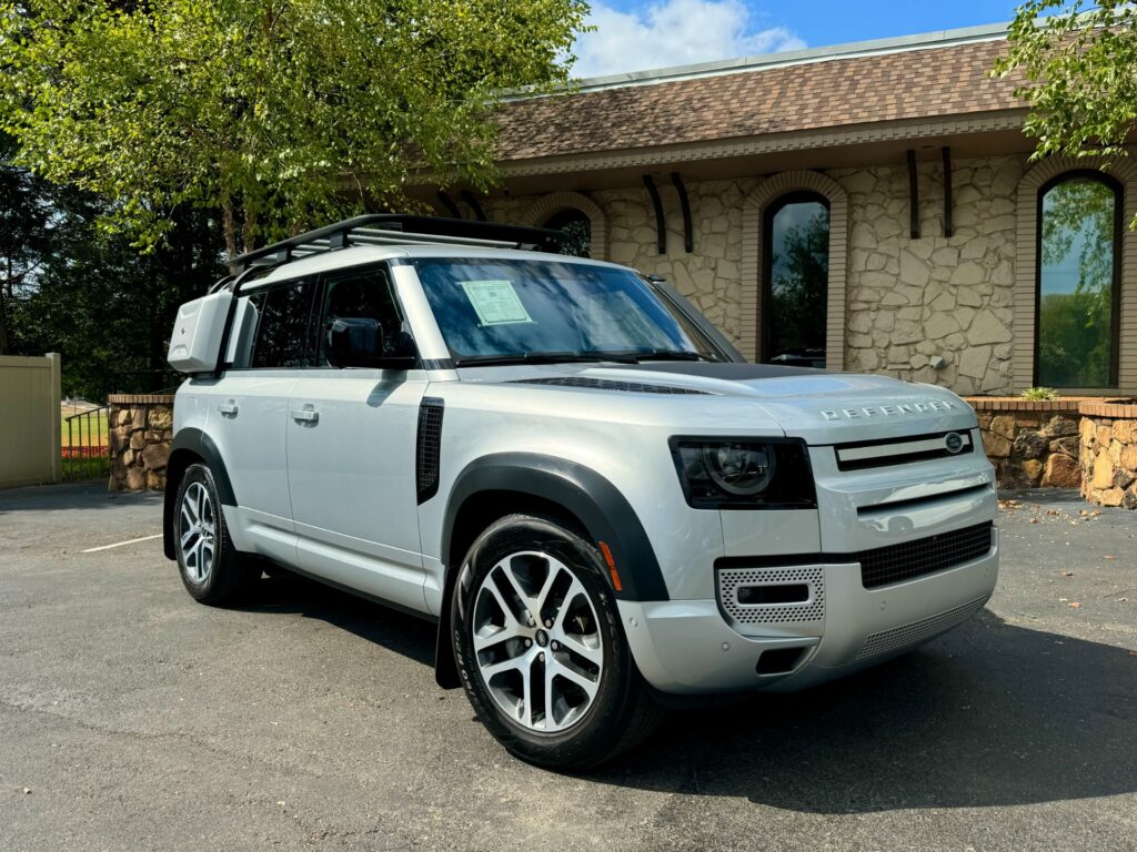 Side view of the 2022 Land Rover Defender 110 XS Edition with Explorer Pack, featuring a third-row seat and roof rack.