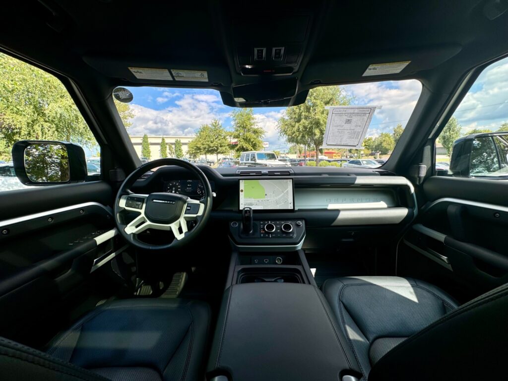 Interior view of the 2022 Land Rover Defender 110 XS Edition with Explorer Pack, featuring a sleek dashboard and advanced navigation system.