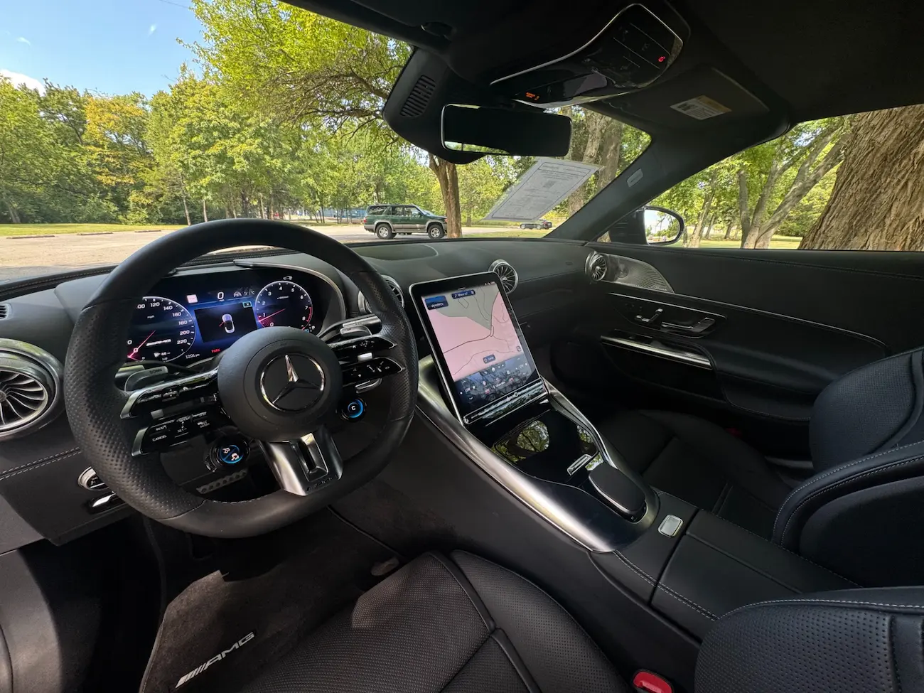 Interior of 2022 Mercedes-AMG SL63 Roadster featuring digital display, AMG steering wheel, and MBUX infotainment system.