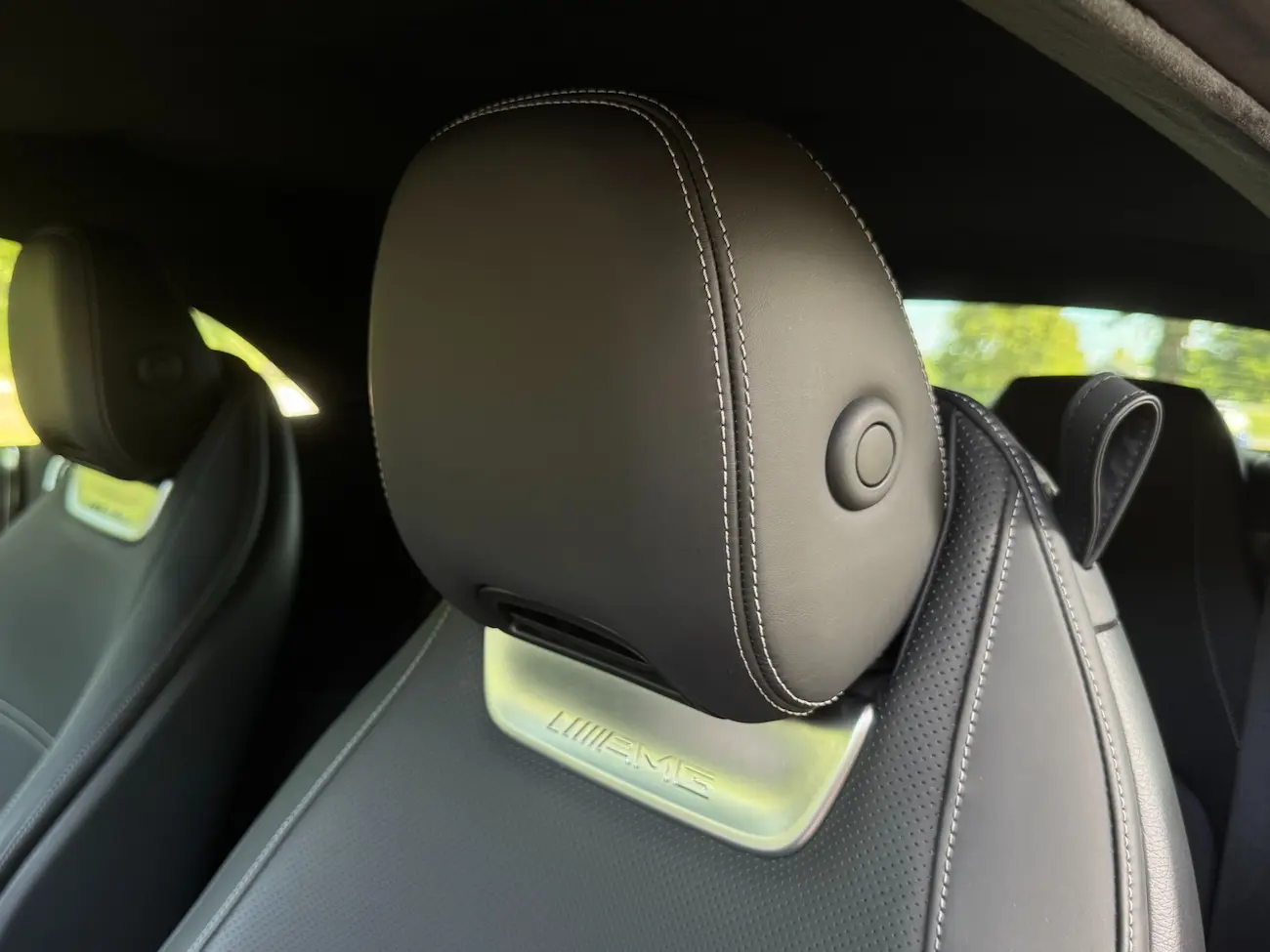 AMG-branded headrest in the 2022 Mercedes-AMG SL63, showcasing luxury leather upholstery with white contrast stitching.