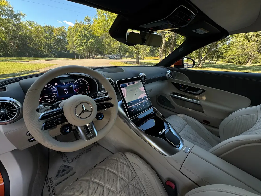 Interior of 2022 Mercedes-Benz SL 63 AMG with quilted leather seats, AMG performance steering wheel, and digital MBUX display.