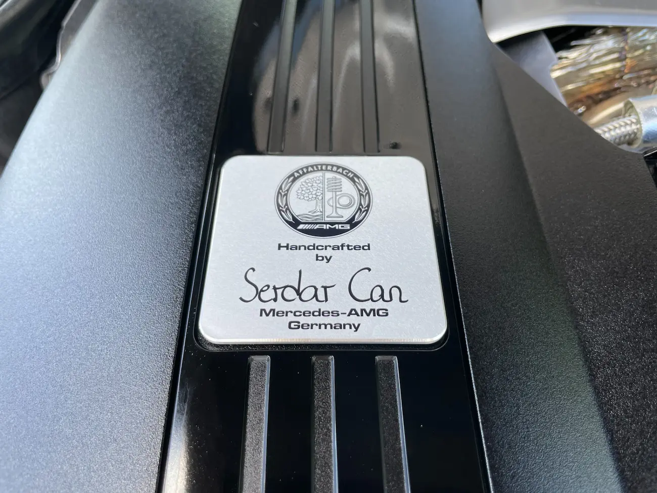 Handcrafted AMG V8 engine plaque signed by Serdar Can on the 2022 Mercedes-AMG SL63, symbolizing AMG’s “One Man, One Engine” philosophy.