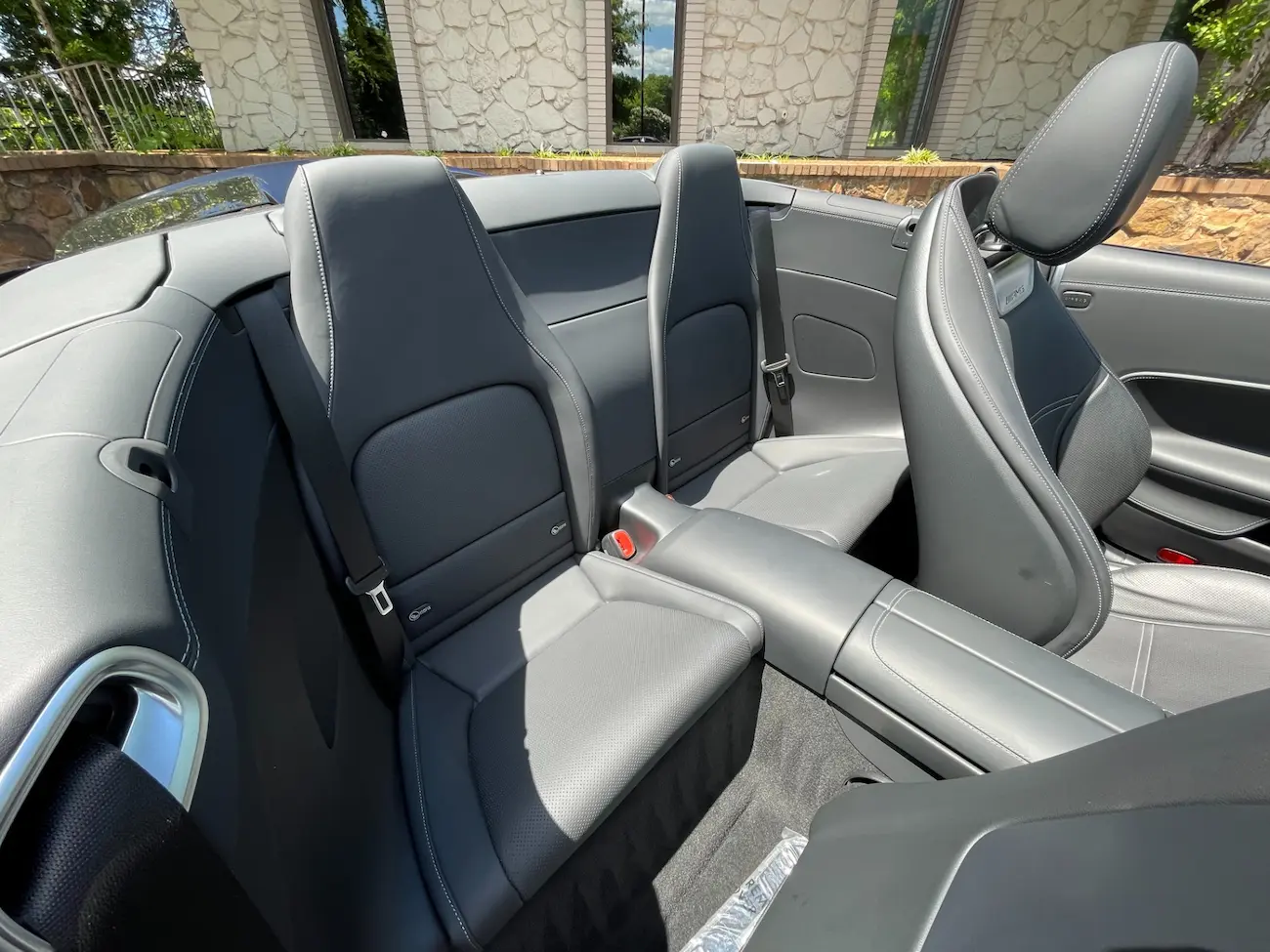 Rear seating area of the 2022 Mercedes-AMG SL 63 Roadster in black leather with white stitching.