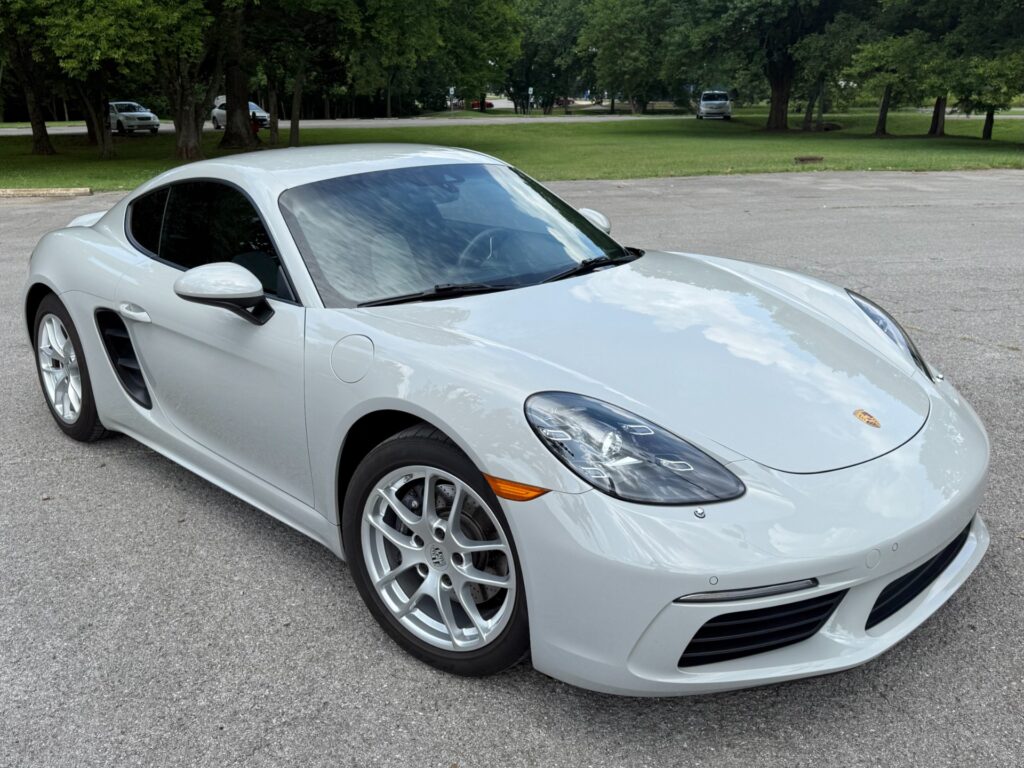 Front view of a 2022 Porsche 718 Cayman T in white parked on pavement