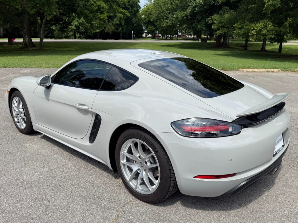 Rear view of a 2022 Porsche 718 Cayman T in white with rear spoiler and LED tail lights