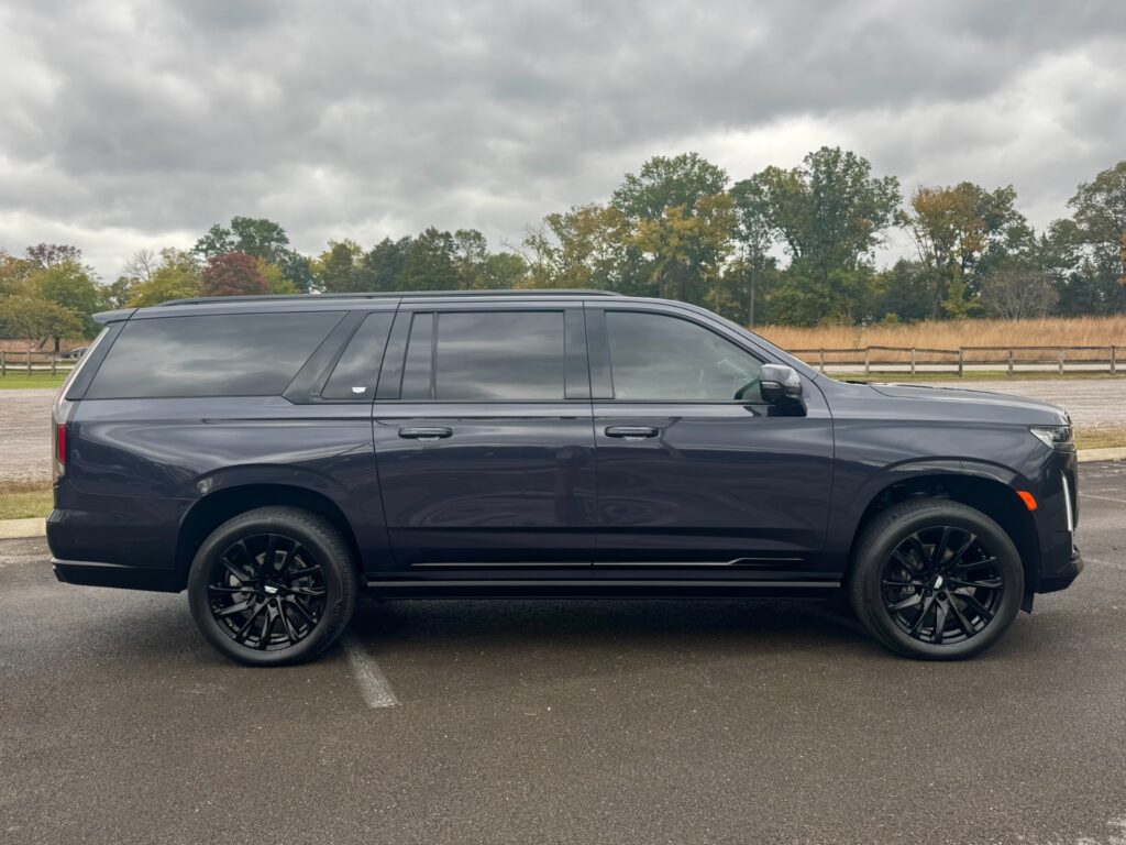 2023 Cadillac Escalade ESV Sport Platinum side profile emphasizing long wheelbase and black alloy wheels.