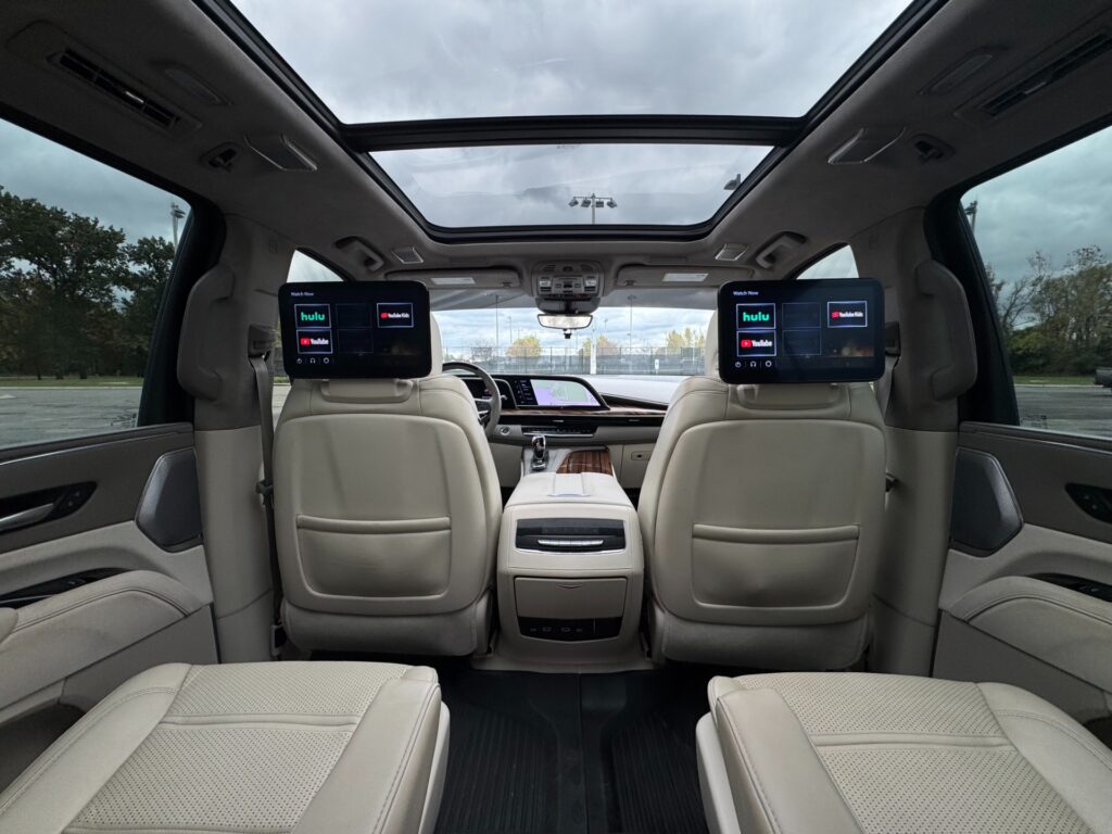 2023 Cadillac Escalade ESV Sport Platinum interior with rear entertainment screens, panoramic roof, and premium leather seats.