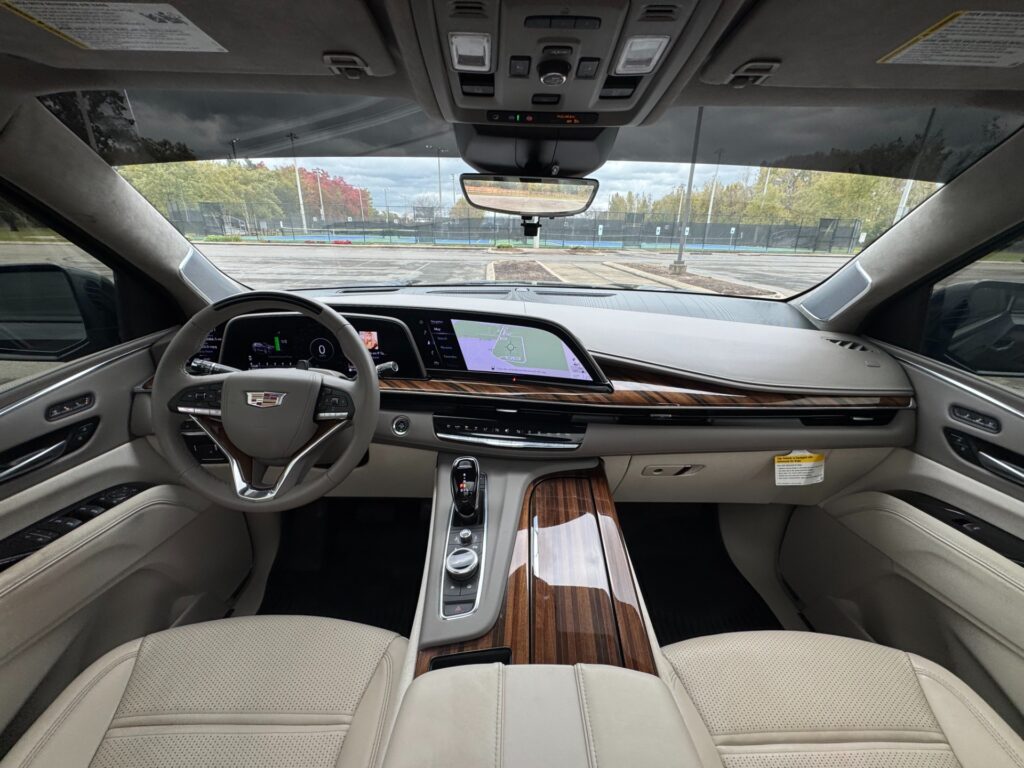 2023 Cadillac Escalade ESV Sport Platinum cockpit featuring OLED curved display, Super Cruise controls, and wood trim.