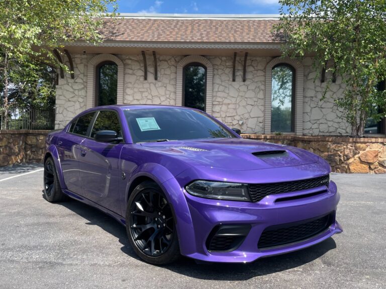 Side angle view of a 2023 Dodge Charger SRT Hellcat Widebody Jailbreak in striking purple at AutoPro Nashville