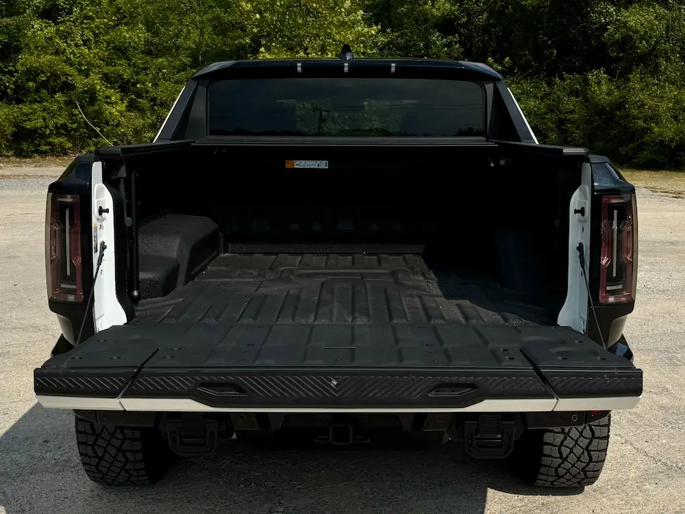 GMC Hummer EV pickup bed with MultiPro tailgate open.