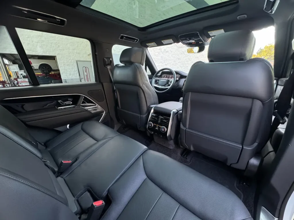 Rear cabin of 2023 Land Rover Range Rover P530 SE with leather seats and panoramic roof.
