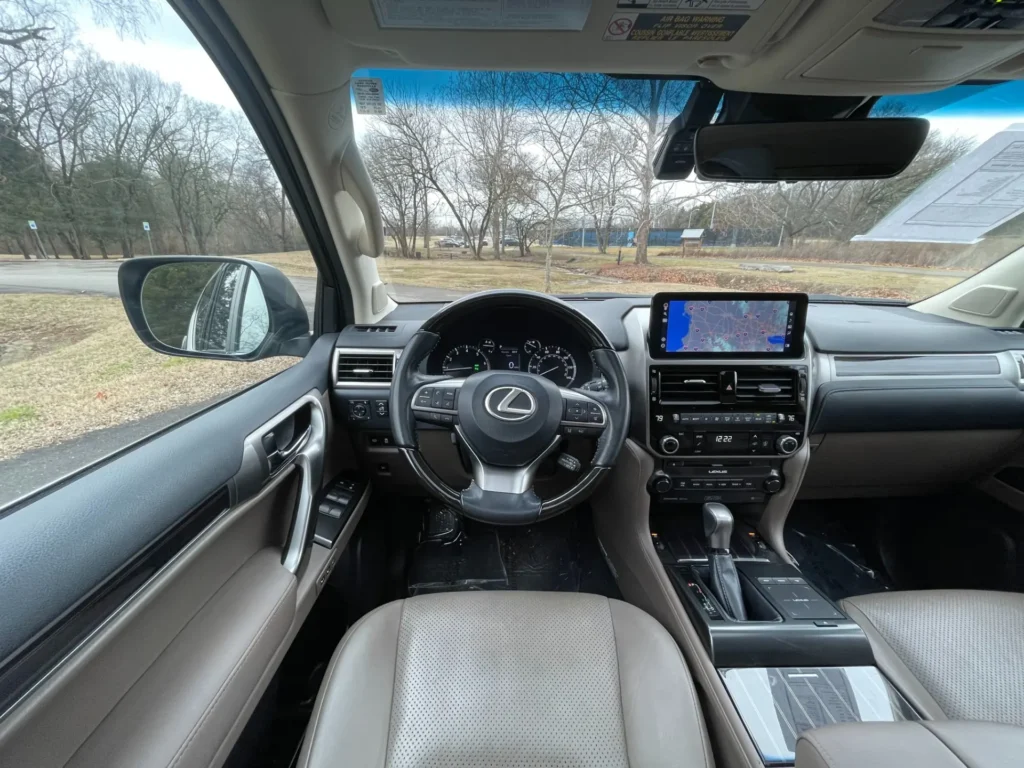 Interior of a 2023 Lexus GX 460 Luxury with Sport Design Package, showing leather seats and infotainment system.