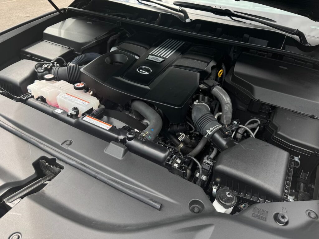 Close-up of the 3.5L V6 twin-turbo engine in the 2023 Lexus LX 600 Premium showing a clean, powerful setup.