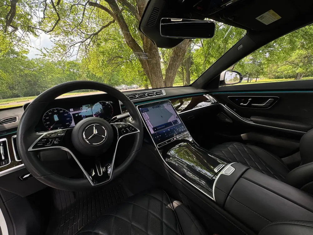 Interior of 2023 Mercedes-Benz S 580 with black quilted seats and high-resolution touchscreen display.