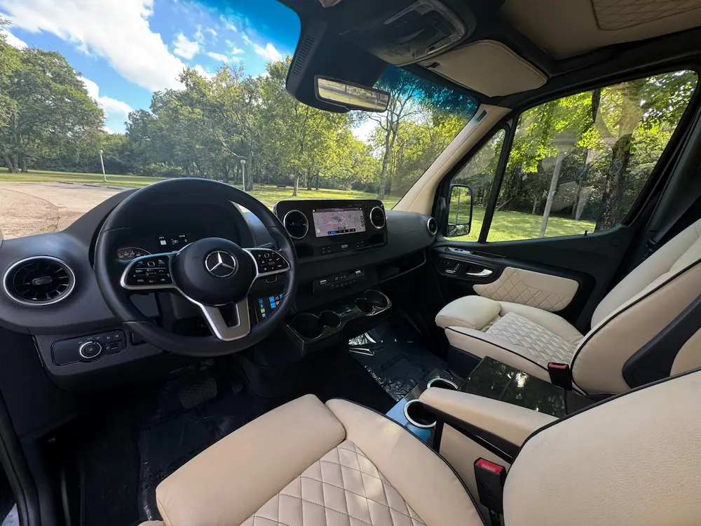 Cockpit of 2023 Mercedes-Benz Sprinter 3500XD Ultimate Limo with leather seats, navigation, and MBUX infotainment.