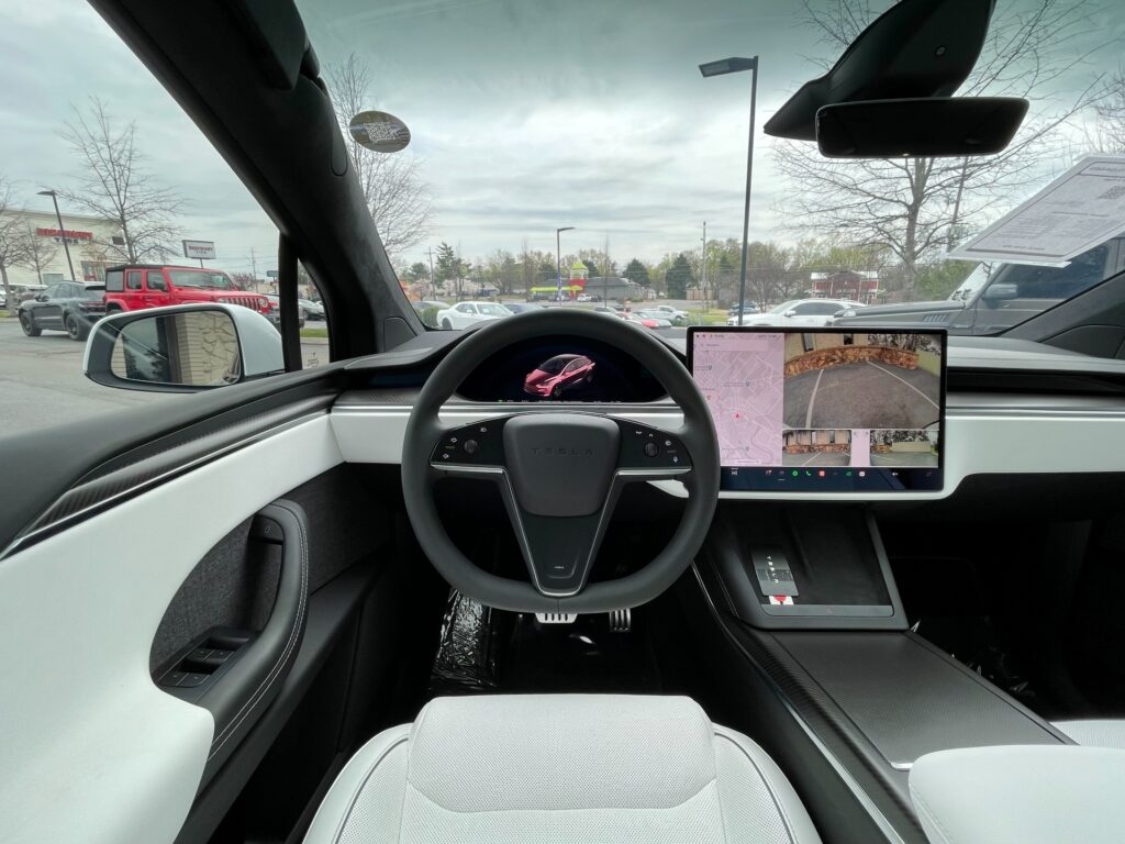 nterior of a Tesla Model X with a camera mounted on the steering wheel. AutoPro Nashville is a used car dealership selling Teslas.