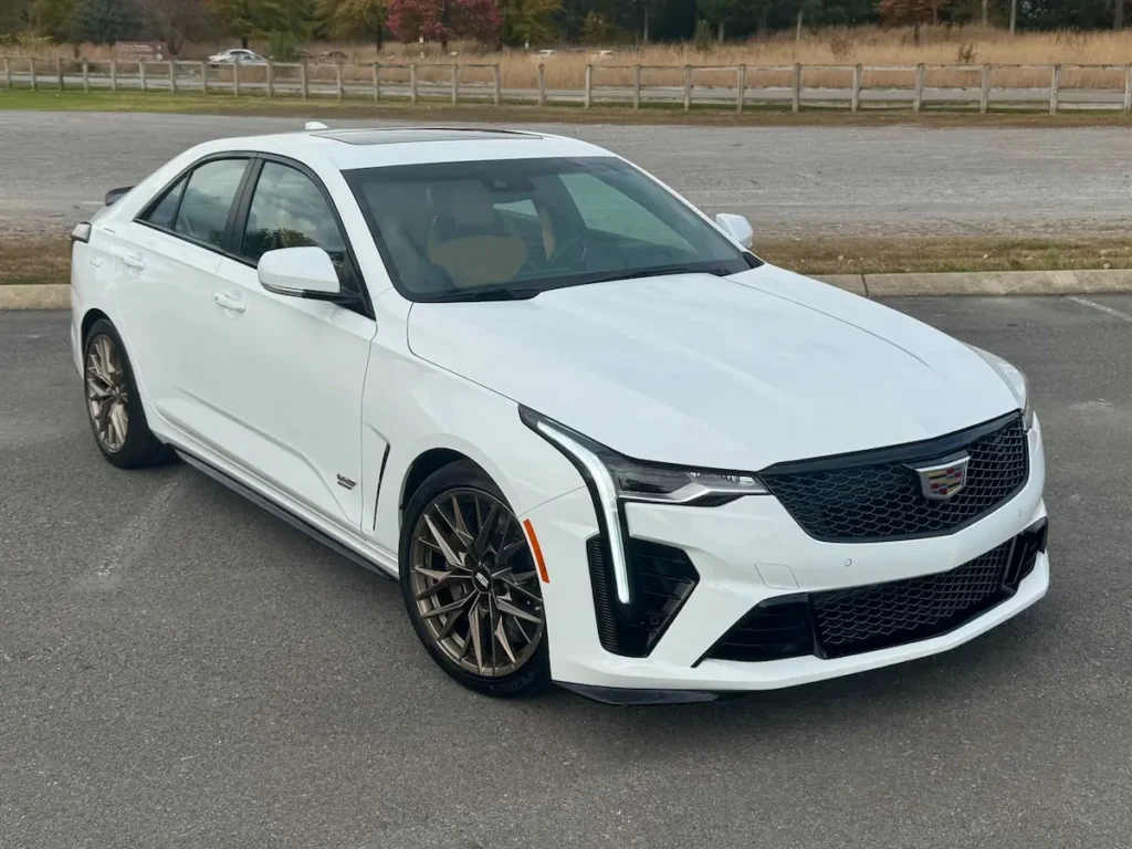 2024 Cadillac CT4-V Blackwing front three-quarter view showing aerodynamic design, V-Series grille, and bronze wheels.