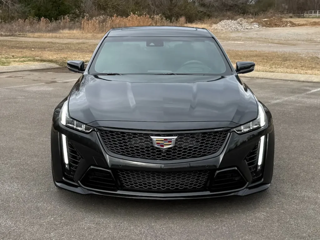 Front view of a black Cadillac CT5-V Blackwing showing grille, LED headlights, and aggressive stance