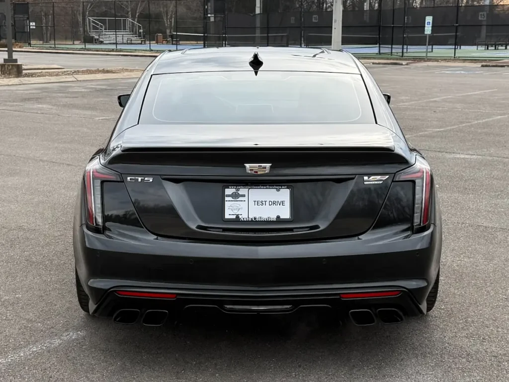 Rear view of a black Cadillac CT5-V Blackwing with quad exhaust and V-Series badging