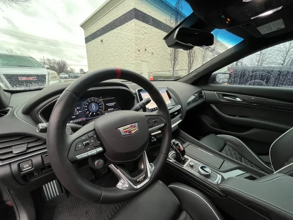 Driver cockpit of a Cadillac CT5-V Blackwing with digital gauge cluster and performance steering wheel