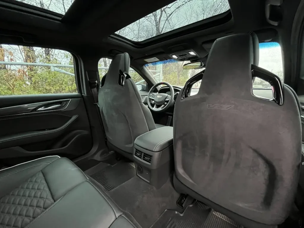 Rear interior of a Cadillac CT5-V Blackwing featuring performance seats and panoramic sunroof