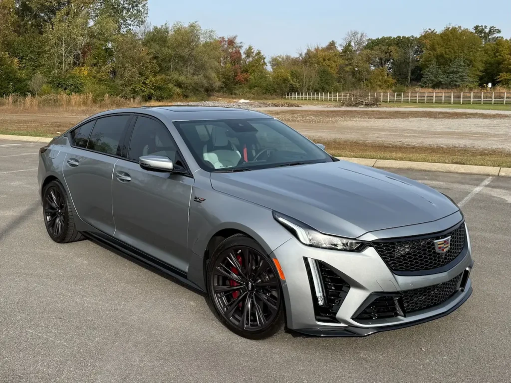 2024 Cadillac CT5-V Blackwing front three-quarter view showing aggressive design, carbon fiber accents, and performance stance.
