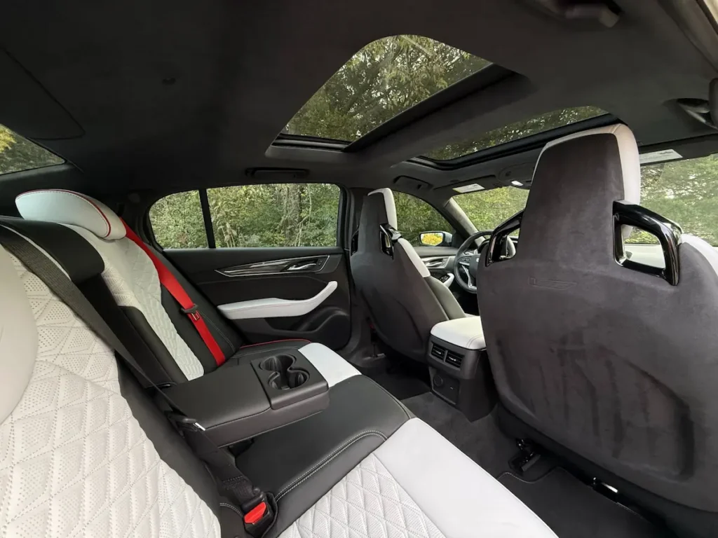 Rear seating in 2024 Cadillac CT5-V Blackwing with premium leather upholstery and red seat belts.