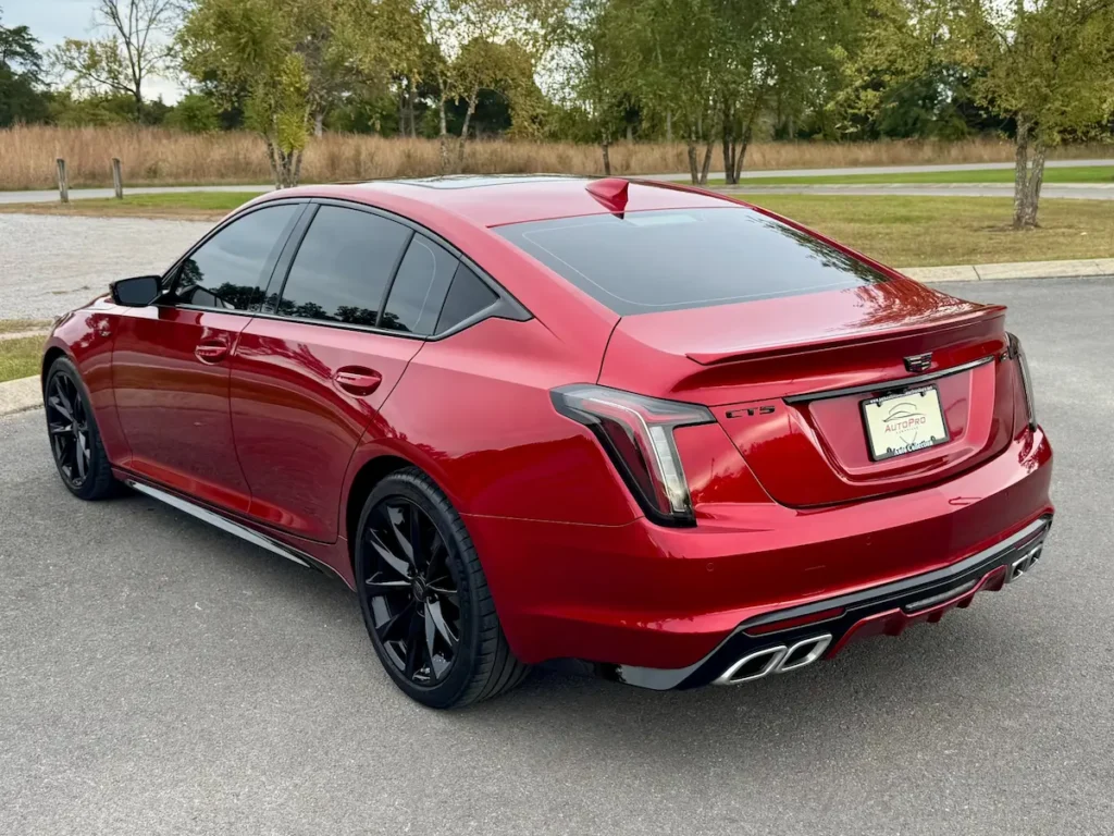 2024 Cadillac CT5-V rear view highlighting quad exhaust outlets, LED taillights, and sporty stance.