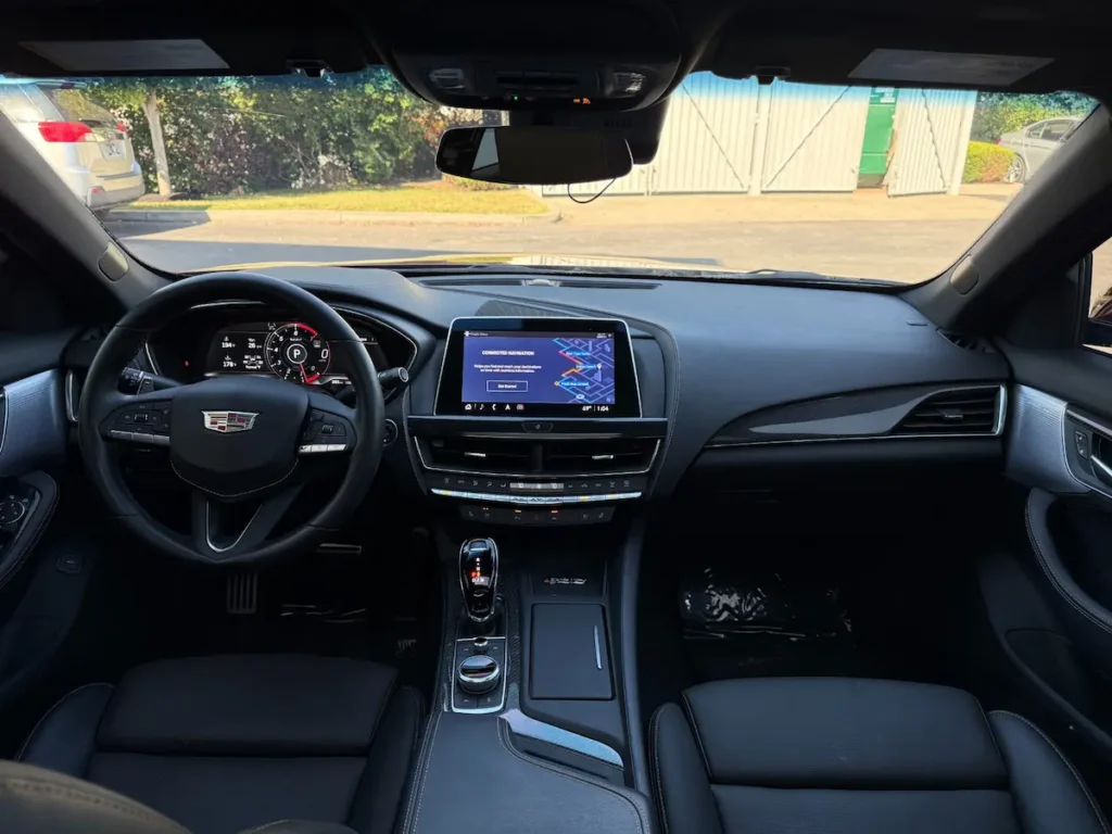 2024 Cadillac CT5-V interior cockpit showing digital cluster, navigation screen, and performance steering wheel.